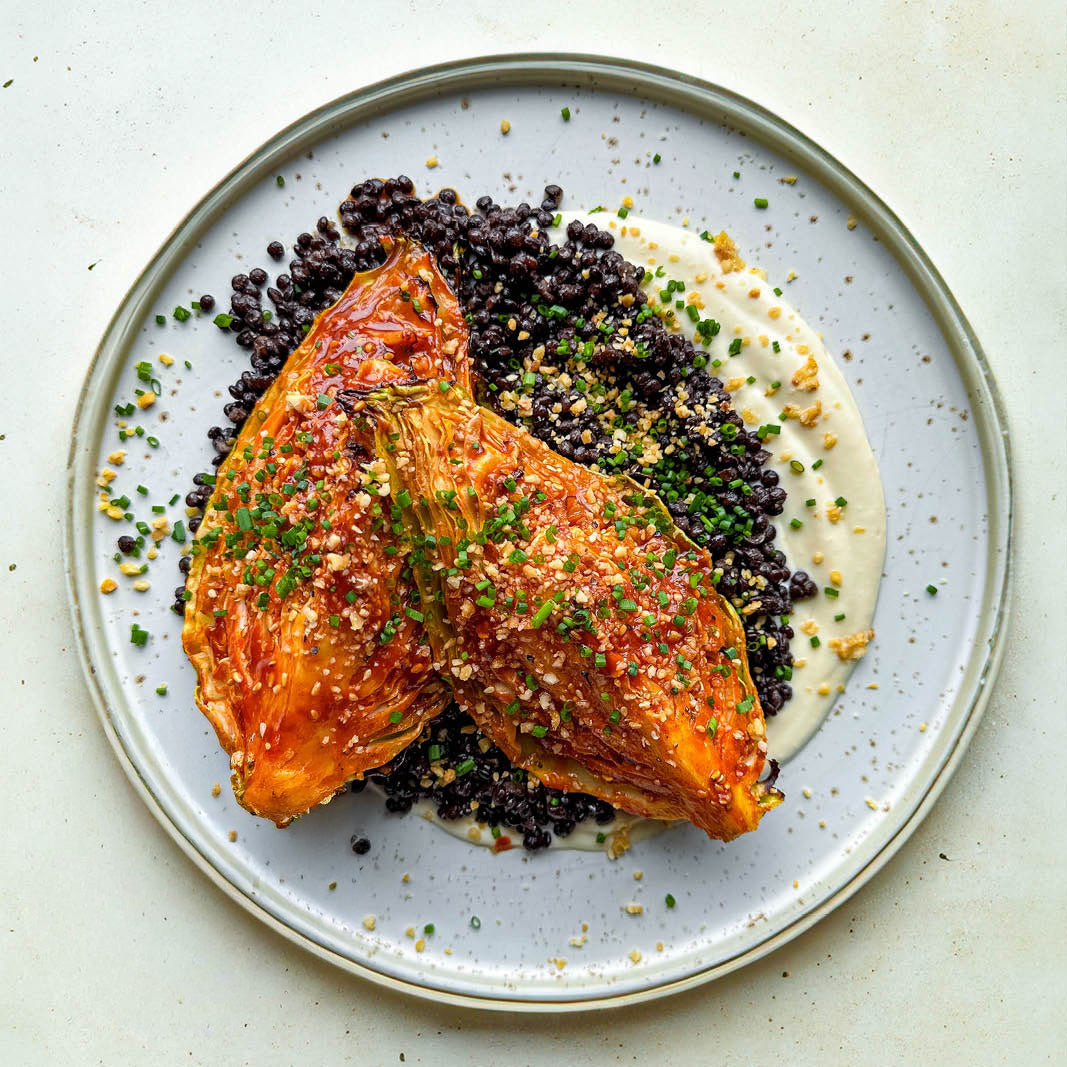 Charred Gochujang Glazed Hispi Cabbage Over Lime Tahini Yoghurt With Lentils & Orange Peanut Crumb