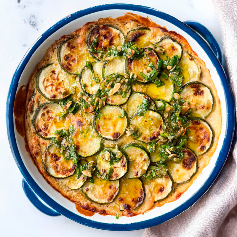 Courgette Gratin With Cashew Cheese Sauce, Creamy Cannellini Beans And Olive & Almond Gremolata