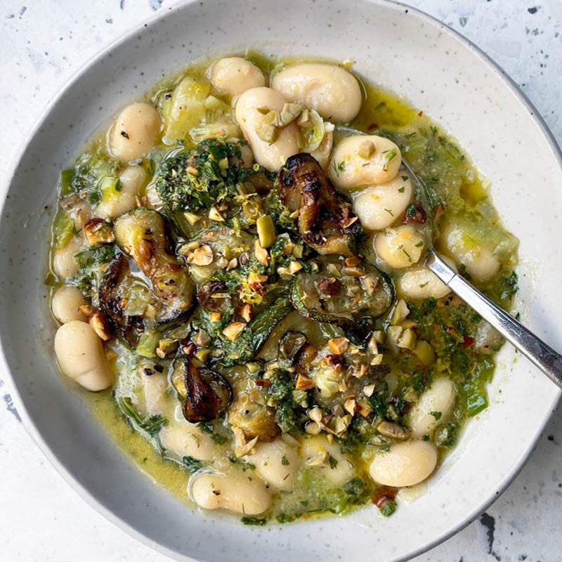 Creamy Butter Beans With Caramelised Leeks, Charred Courgettes, Drizzled With Olive & Almond Pesto