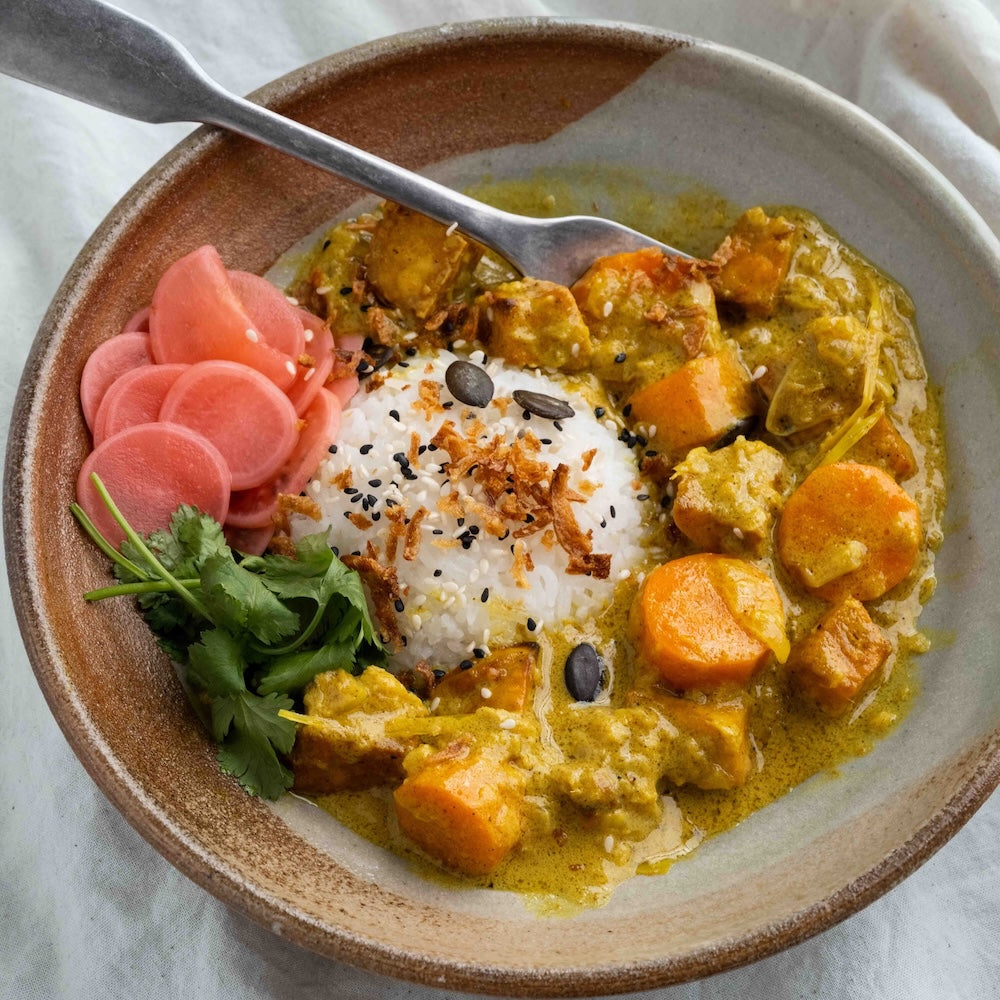 Creamy Vietnamese Coconut Curry With Tofu, Sweet Potato, Crispy Shallots, Pickled Radish, Cashews & Sesame Seeds