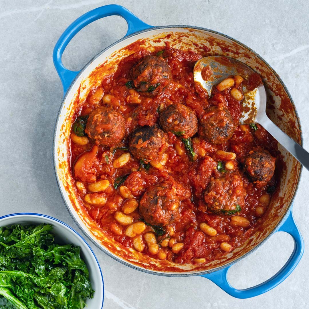 High Protein Tempeh Meatballs In Smoky Tomato Sauce With Cannellini Beans & Braised Green Kale
