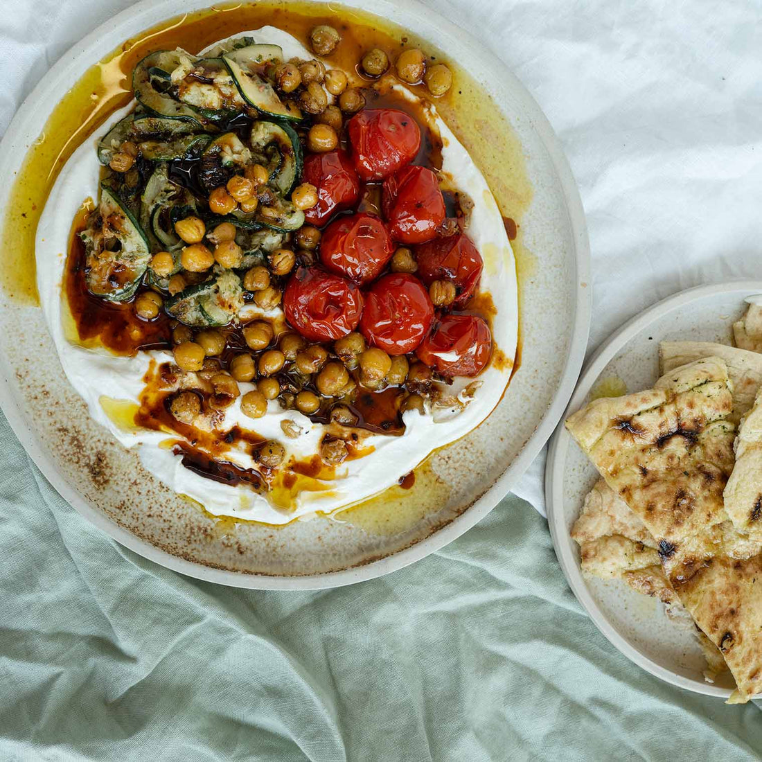 Hot 'Honey' Labneh Mezze With Minted Courgettes, Roasted Cherry Tomatoes, Chickpeas & Freshly Baked Garlic Flatbread
