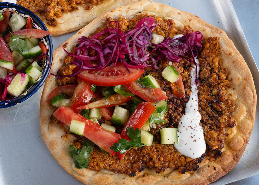 Lahmacun Flatbread With Meaty Spiced Tofu Crumble, Tomato, Cucumber, Sumac Pickled Onion & Garlic Yoghurt
