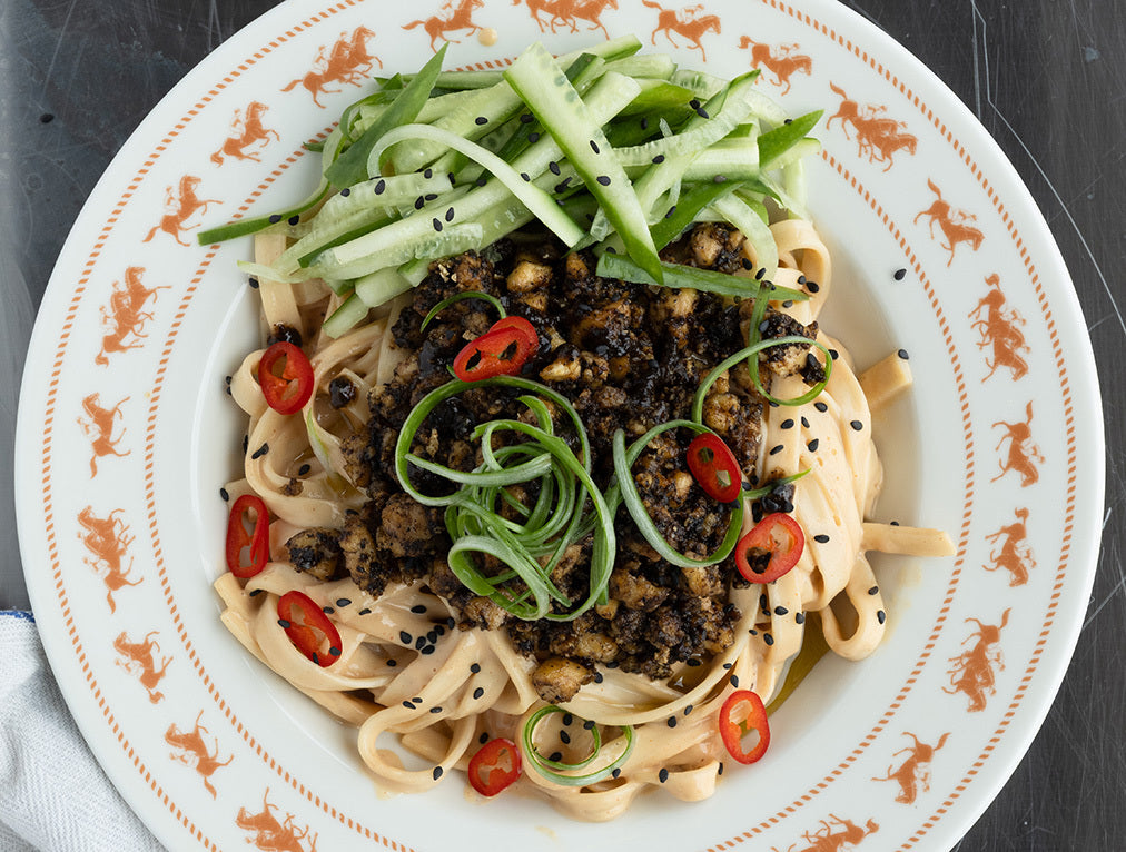 Mapo Tofu Udon Noodles In Creamy Gochujang Sauce With Fresh Cucumber Salad & Toasted Sesame Seeds