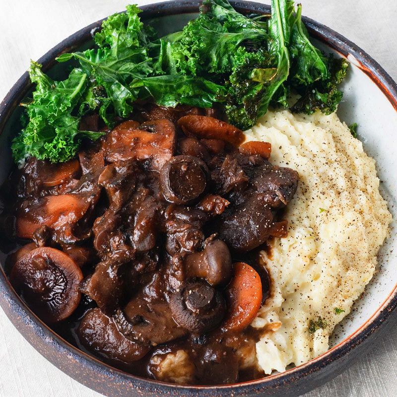 Slow-Cooked Mushroom Bourguignon Over Creamy Mash With Green Kale