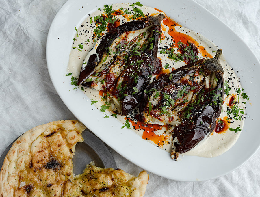 Smoky Whole Roasted Aubergine Over Creamy Whipped Tahini With Hot Agave Harissa, Fresh Parsley & Flatbreads